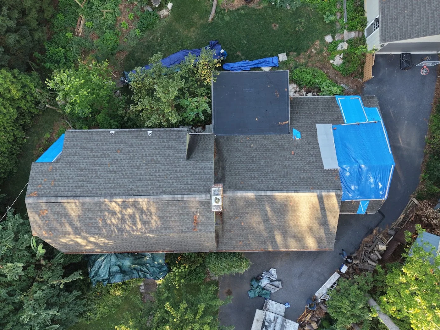 Overhead view of blue tarps on a home