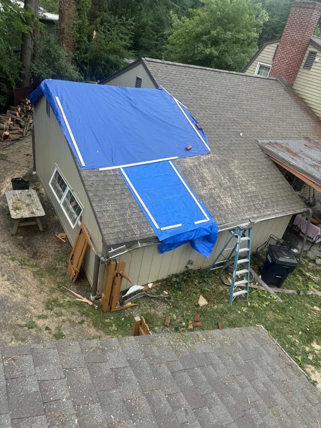 Blue tarps on a residential roof seen from above