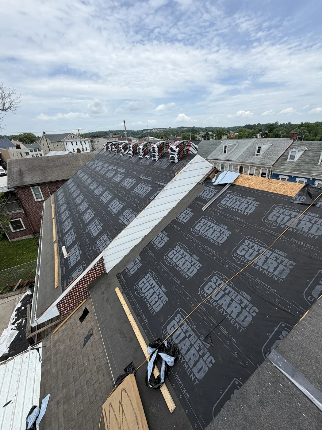 Roof underlayment being installed