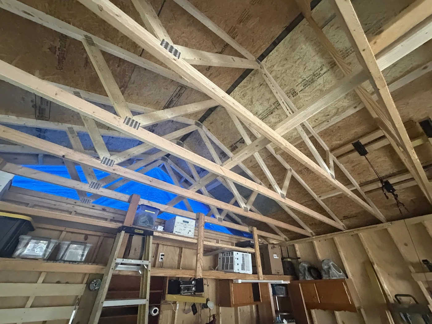 Exposed wooden roof framing seen indoors