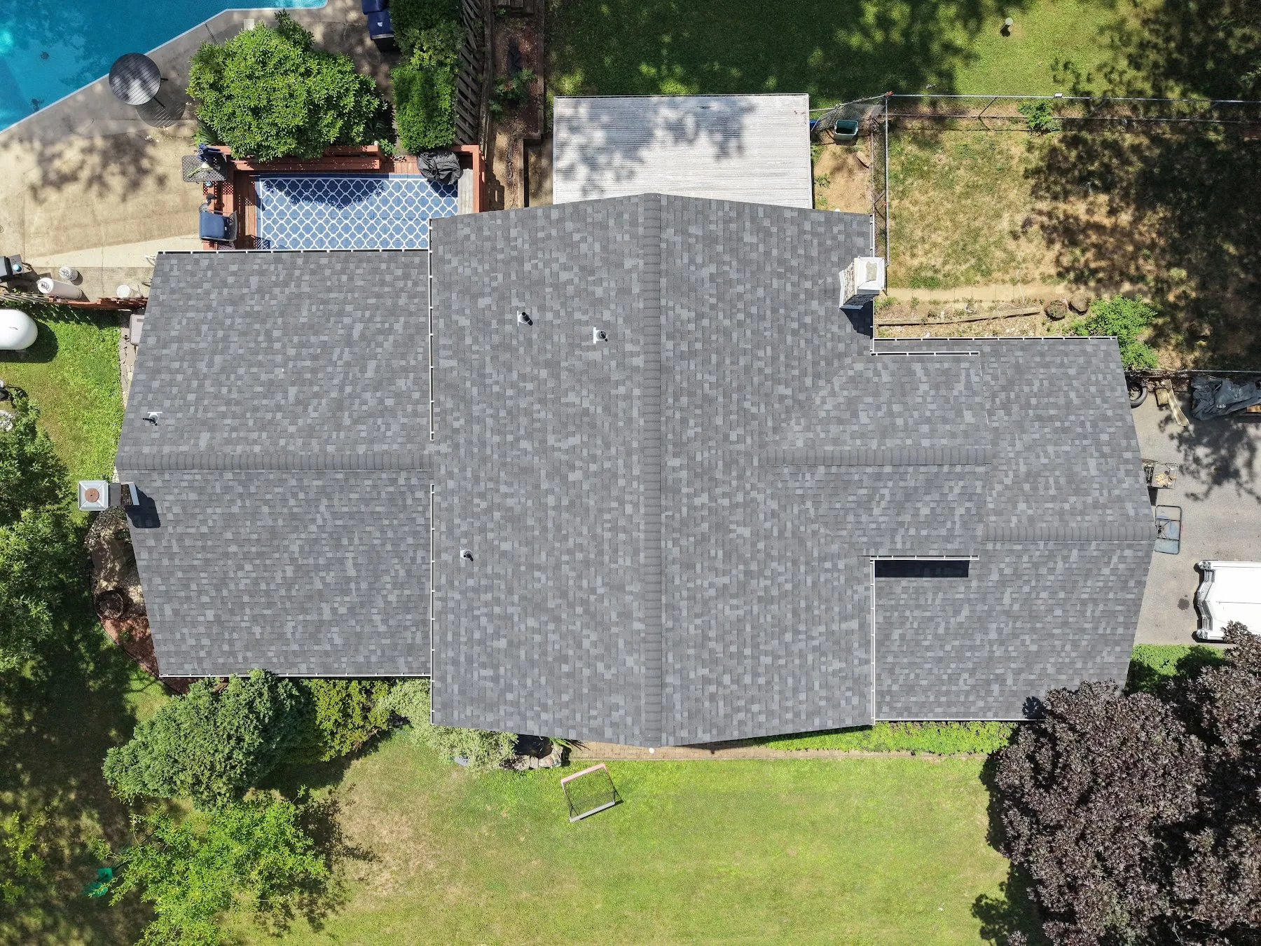 Aerial view of a home's roof and yard
