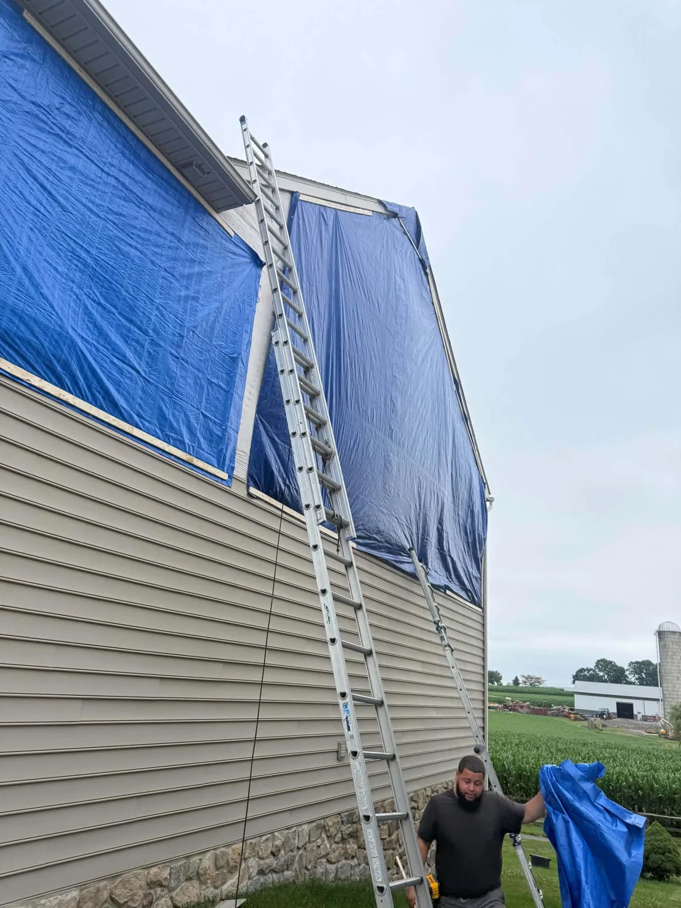 Blue tarp protecting the side of a home