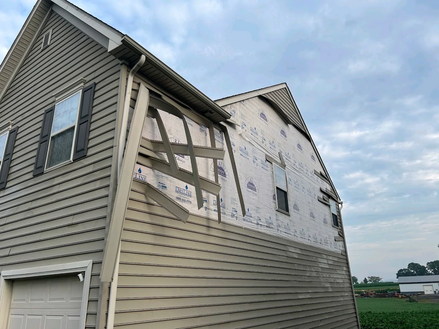 Exposed siding and sheathing on a home