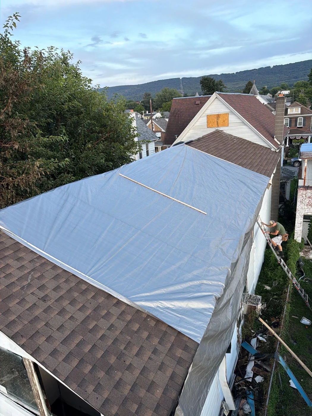 Blue roof tarp photographed from a lift