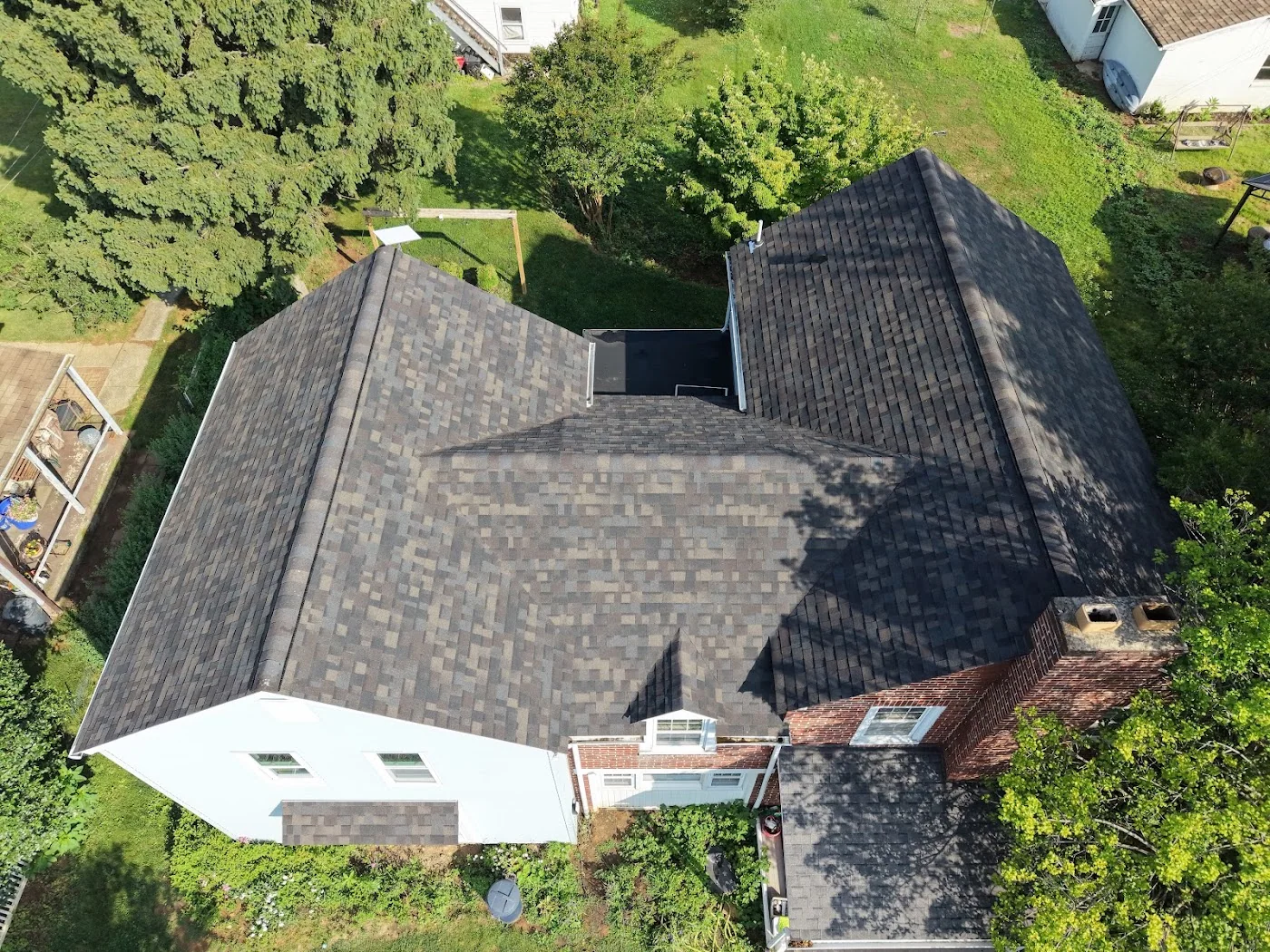 Dark shingle roof beside a swimming pool