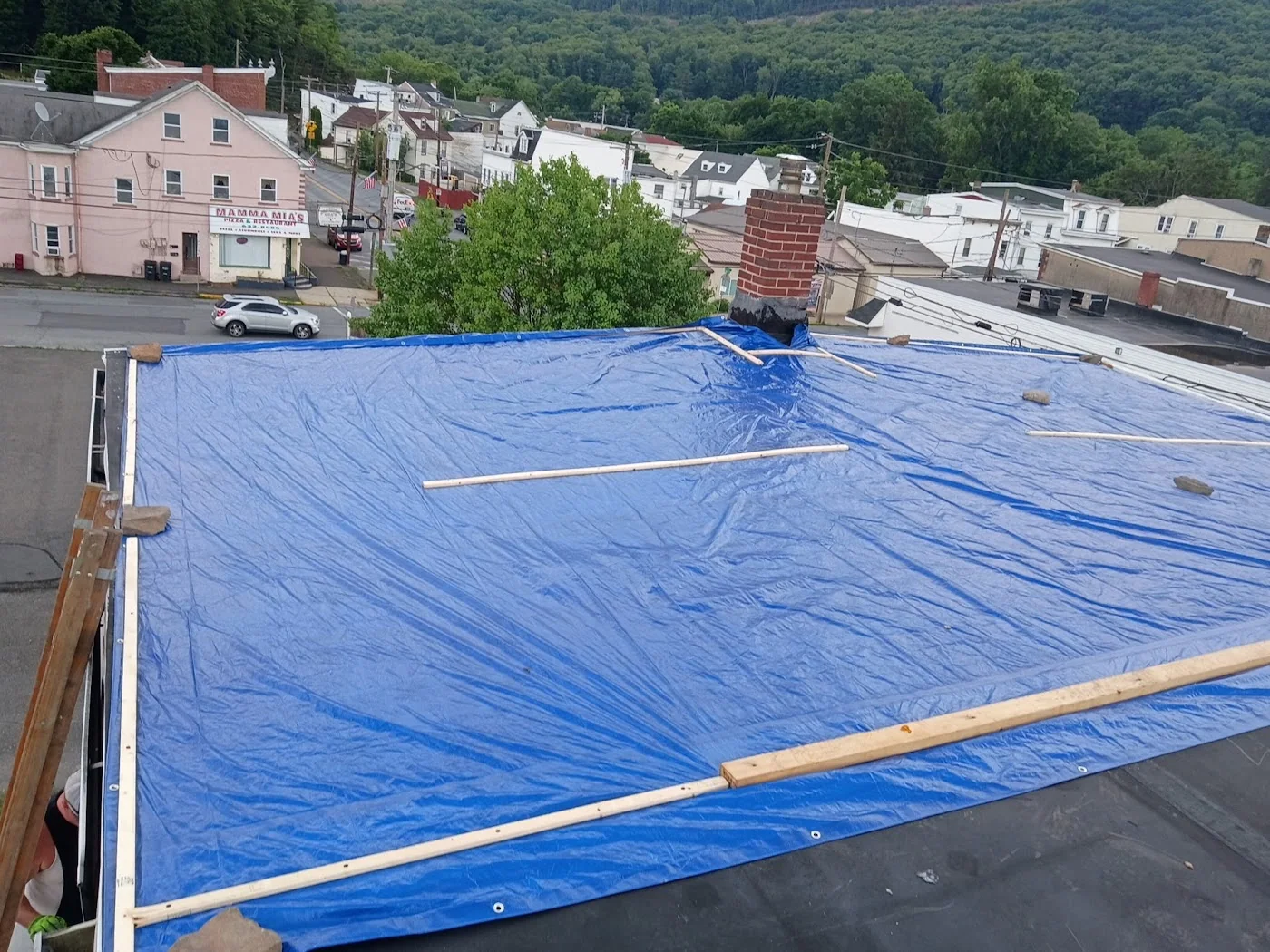 Blue tarp secured on a low-slope roof
