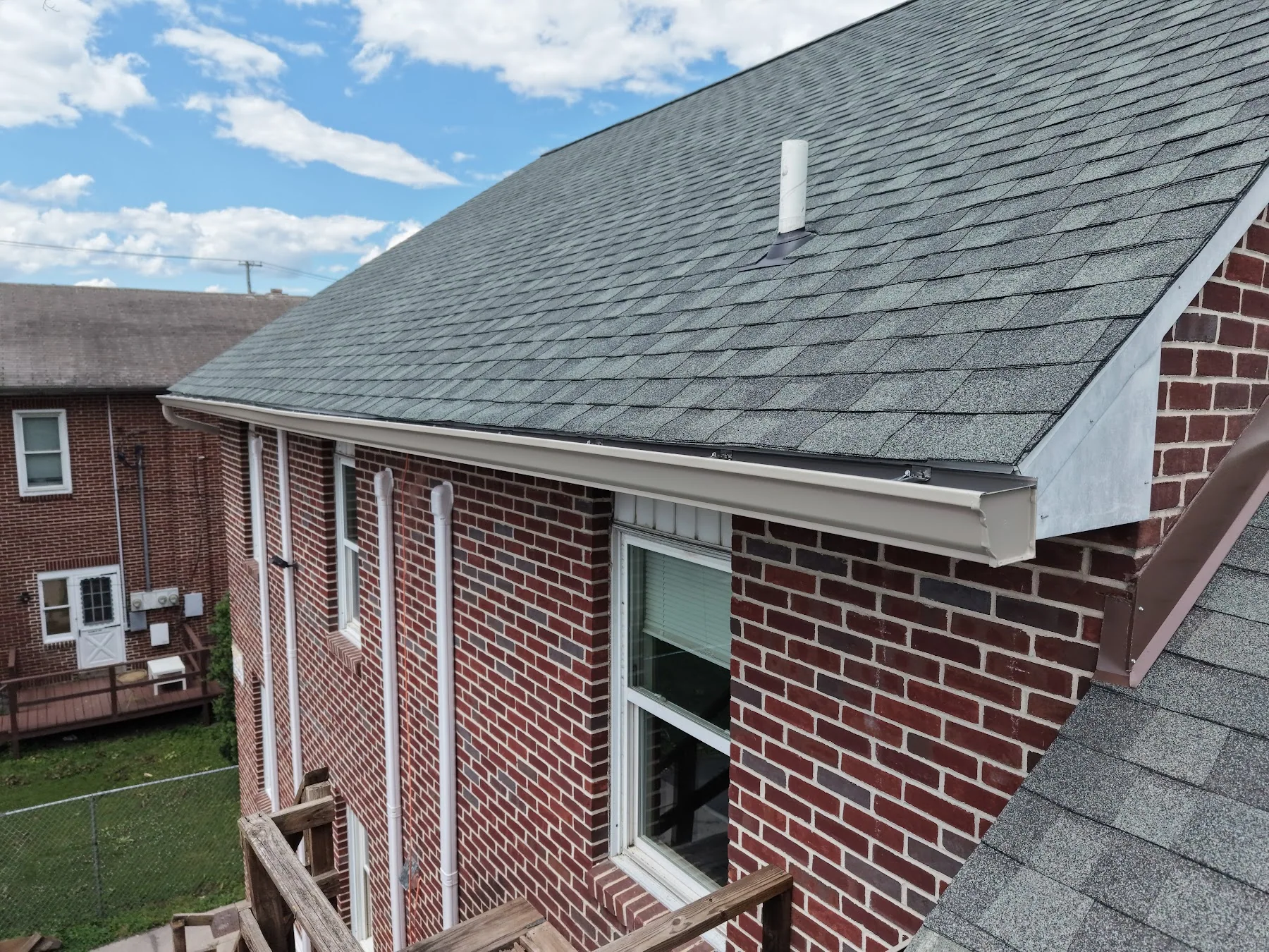 Shingle roof and gutter on a brick home